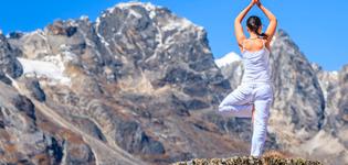 A foreign lady on top of hill in Dharamshala with tree pose - square image