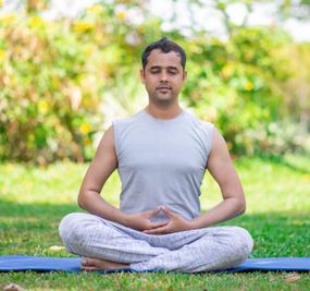 focused-young-indian-man-meditating-lotus-pose-1-768x513