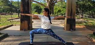 Sri Sri Lemurrian Yoga warrior pose with Indian girl
