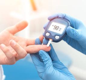 Doctor checking blood sugar level with glucometer. Treatment of diabetes concept.