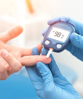 Doctor checking blood sugar level with glucometer. Treatment of diabetes concept.