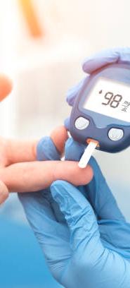 Doctor checking blood sugar level with glucometer. Treatment of diabetes concept.