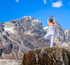 A foreign lady on top of hill in Dharamshala with tree pose - square image