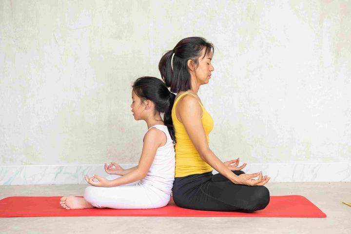 woman-her-charming-little-daughter-doing-yoga_hero