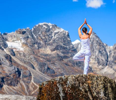 A foreign lady on top of hill in Dharamshala with tree pose - square image