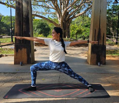 Sri Sri Lemurrian Yoga warrior pose with Indian girl